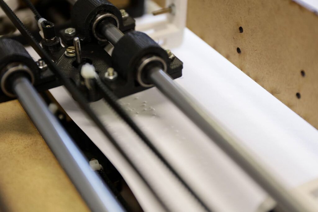 Foto da impressora em braille em ação, desenvolvida por estudantes do Colégio Sesi Internacional.